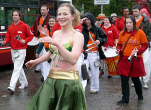 Smiling woman dancing in a green outfit