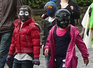 Three children with face paints and balaclavas