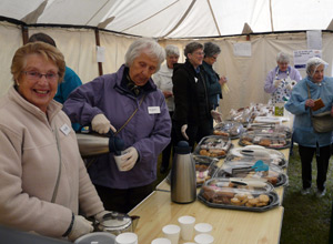 Two women pouring teas in the Leith Churches tea tent