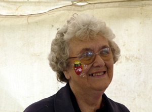 Smiling woman with one of the Leith Festival Monsters painted on her cheek