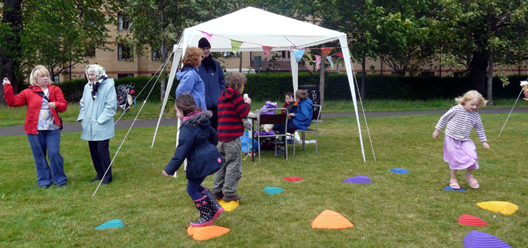 Children jumping on and off brightly coloured plastice stepping stones