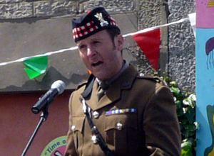 Head and shoulders picture of Major Jules McElhinney speaking